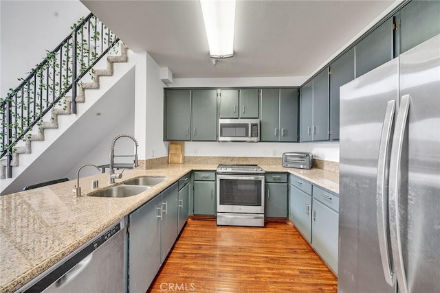 625 S Berendo St Unit 604, Los Angeles, CA 90005 - kitchen with appliances with stainless steel finishes, light wood-type flooring, and light stone countertops