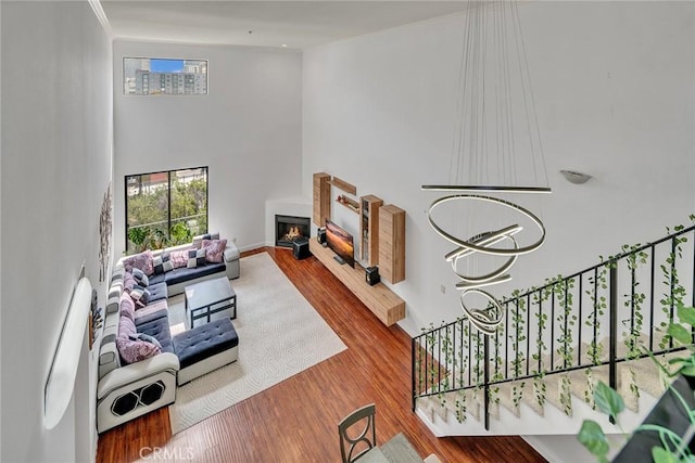 625 S Berendo St Unit 604, Los Angeles, CA 90005 - living room with wood finished floors, stairs, and a lit fireplace