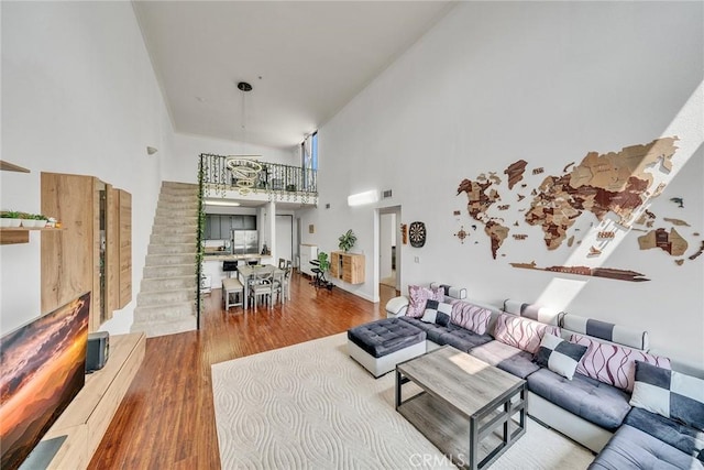 625 S Berendo St Unit 604, Los Angeles, CA 90005 - living room with a high ceiling, wood finished floors, and stairway