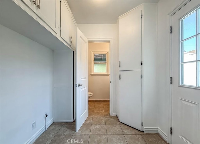 6706 Melvin Ave, Reseda, CA 91335 - laundry room featuring light tile patterned floors and cabinet space