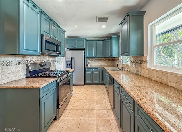 6706 Melvin Ave, Reseda, CA 91335 - kitchen featuring stainless steel appliances, light tile patterned flooring, light stone countertops, decorative backsplash, and recessed lighting