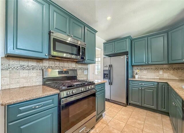 6706 Melvin Ave, Reseda, CA 91335 - kitchen with stainless steel appliances, light tile patterned flooring, tasteful backsplash, recessed lighting, and a textured ceiling