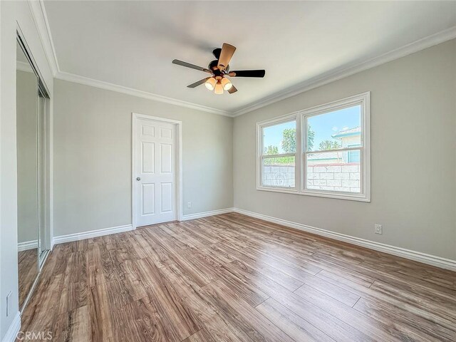 6706 Melvin Ave, Reseda, CA 91335 - unfurnished bedroom with wood finished floors, ornamental molding, ceiling fan, and a closet