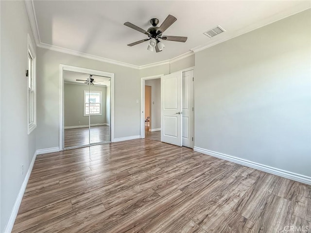 6706 Melvin Ave, Reseda, CA 91335 - unfurnished bedroom with wood finished floors, ornamental molding, a ceiling fan, and a closet
