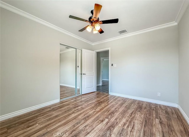 6706 Melvin Ave, Reseda, CA 91335 - unfurnished bedroom featuring wood finished floors, ornamental molding, a closet, and a ceiling fan