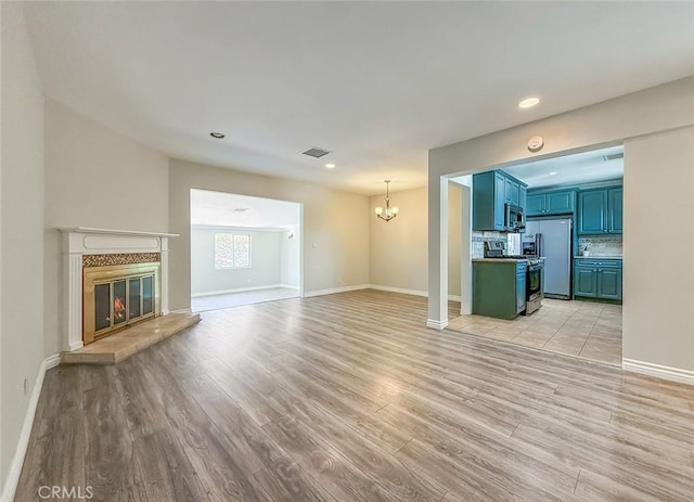 6706 Melvin Ave, Reseda, CA 91335 - unfurnished living room featuring a chandelier, light wood finished floors, recessed lighting, and a fireplace