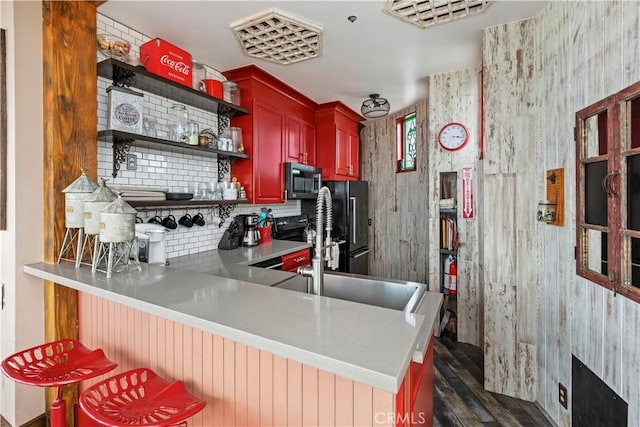 1 Anderson St, Seal Beach, CA 90743 - kitchen with dark brown cabinets, dark wood-style flooring, tasteful backsplash, open shelves, and black appliances