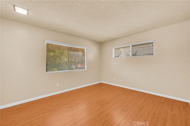 20468 College Blvd, Riverside, CA 92507 - empty room featuring light wood-style floors and a textured ceiling