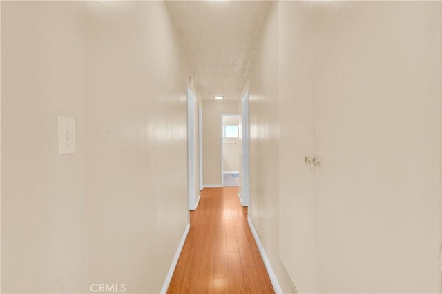 20468 College Blvd, Riverside, CA 92507 - corridor with a textured ceiling and light wood finished floors