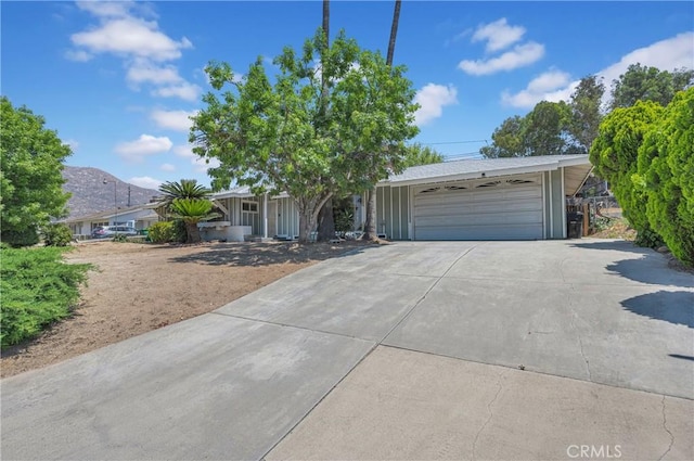 20468 College Blvd, Riverside, CA 92507 - view of front of house featuring concrete driveway, a mountain view, and an attached garage