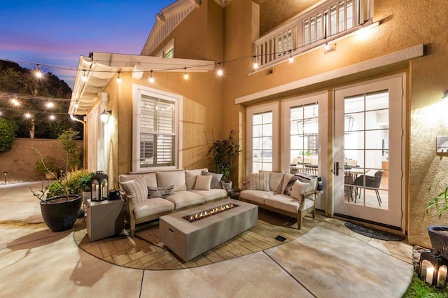 3474 Camino Cereza, Carlsbad, CA 92009 - patio terrace at dusk with french doors, an outdoor living space with a fire pit, and a patio area