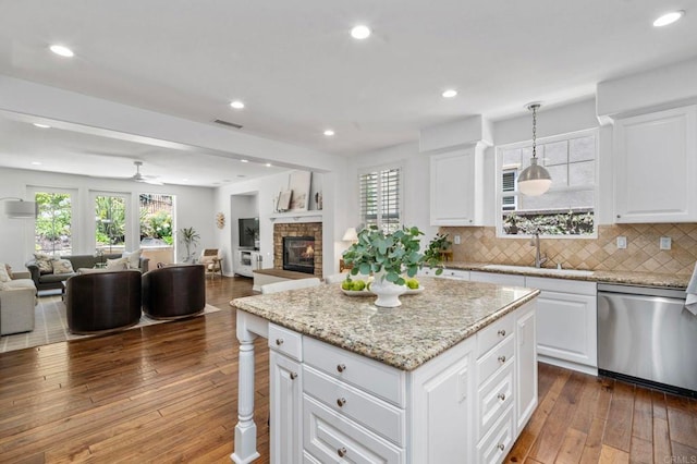 3474 Camino Cereza, Carlsbad, CA 92009 - kitchen featuring stainless steel dishwasher, open floor plan, dark wood-style flooring, a center island, and decorative backsplash