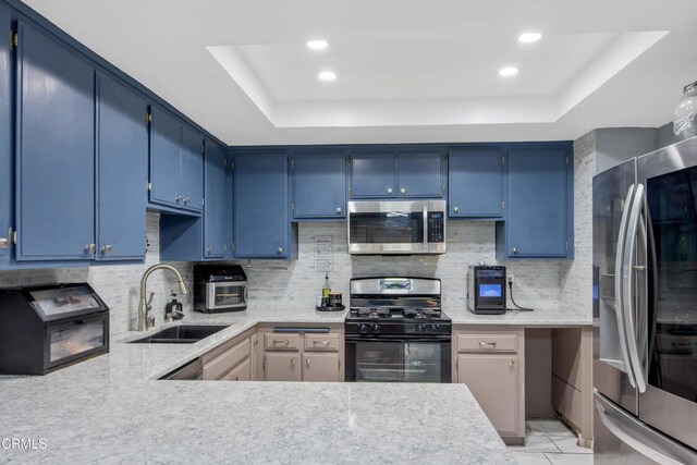 502 Holly Ave, Oxnard, CA 93036 - kitchen featuring appliances with stainless steel finishes, a raised ceiling, blue cabinets, backsplash, and recessed lighting