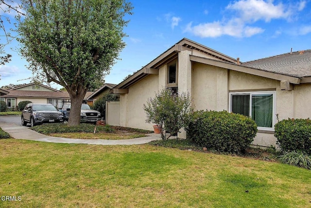 502 Holly Ave, Oxnard, CA 93036 - view of side of home featuring stucco siding and a yard
