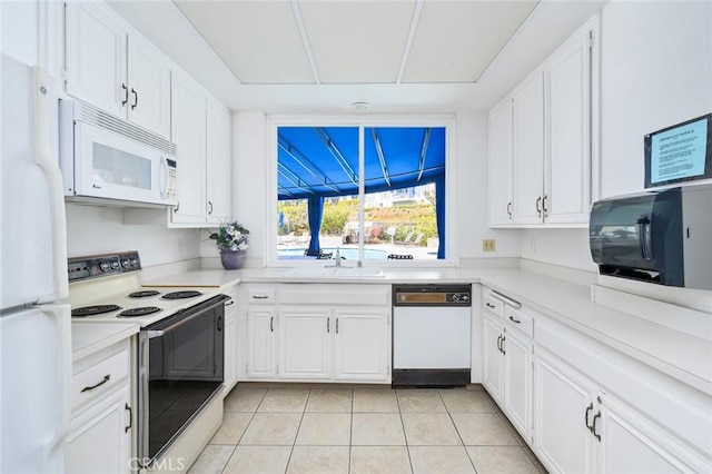 100 Scholz Plz Unit 205, Newport Beach, CA 92663 - kitchen featuring white appliances, light countertops, white cabinets, and light tile patterned flooring