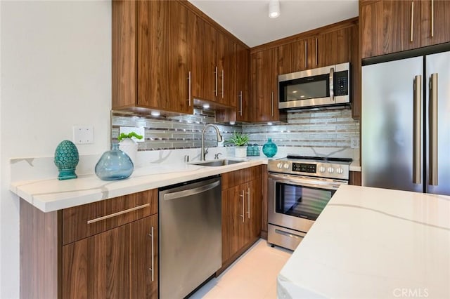 100 Scholz Plz Unit 205, Newport Beach, CA 92663 - kitchen with appliances with stainless steel finishes, light countertops, and tasteful backsplash