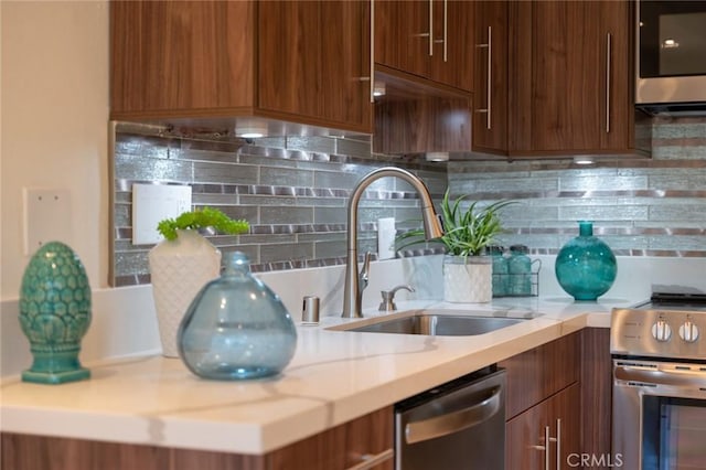 100 Scholz Plz Unit 205, Newport Beach, CA 92663 - kitchen with stainless steel appliances, light countertops, tasteful backsplash, modern cabinets, and brown cabinetry