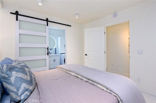 100 Scholz Plz Unit 205, Newport Beach, CA 92663 - bedroom with washer / clothes dryer, a barn door, and ensuite bathroom