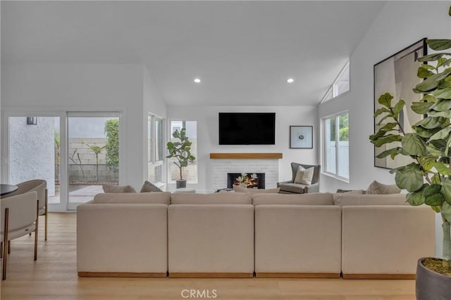 20441 Whitetree Cir, Huntington Beach, CA 92646 - living room featuring vaulted ceiling, a fireplace, light wood-type flooring, and recessed lighting