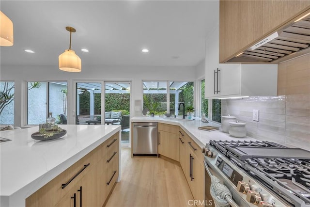 20441 Whitetree Cir, Huntington Beach, CA 92646 - kitchen with appliances with stainless steel finishes, light brown cabinets, under cabinet range hood, light wood-style floors, and recessed lighting