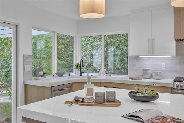 20441 Whitetree Cir, Huntington Beach, CA 92646 - kitchen with stainless steel appliances, modern cabinets, tasteful backsplash, and white cabinetry