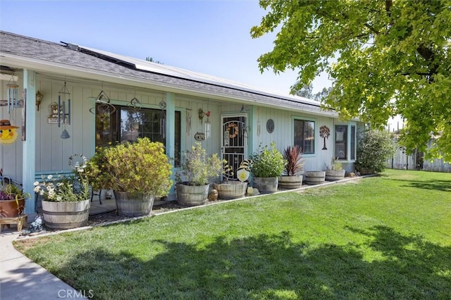 7050 Shale Rock Rd, Paso Robles, CA 93446 - view of front of property with covered porch, a front lawn, solar panels, and roof with shingles