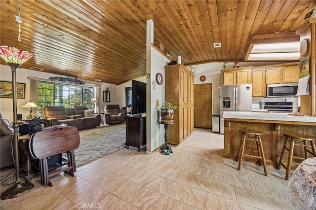 7050 Shale Rock Rd, Paso Robles, CA 93446 - kitchen featuring tile counters, appliances with stainless steel finishes, lofted ceiling, wood ceiling, and open floor plan