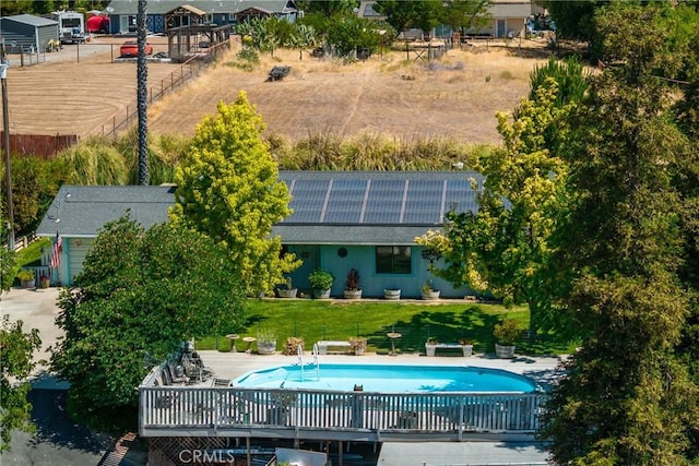 7050 Shale Rock Rd, Paso Robles, CA 93446 - back of house with roof mounted solar panels, an outdoor pool, and a lawn