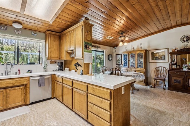 7050 Shale Rock Rd, Paso Robles, CA 93446 - kitchen featuring stainless steel dishwasher, wood ceiling, a peninsula, brown cabinets, and tile counters