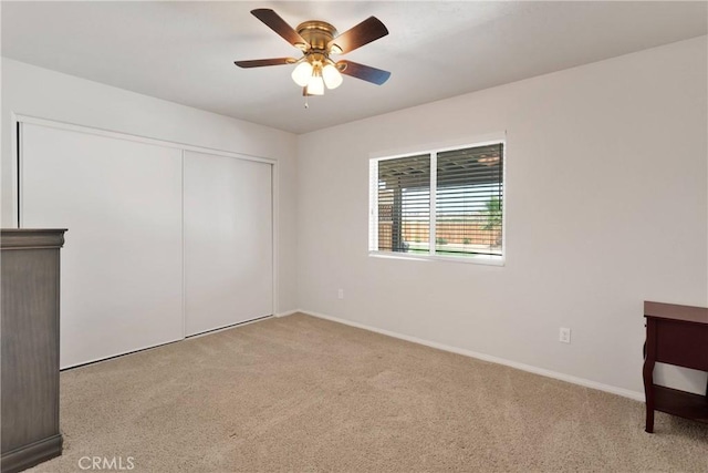 15558 Lookout Rd, Apple Valley, CA 92307 - unfurnished bedroom featuring light carpet, a closet, and a ceiling fan