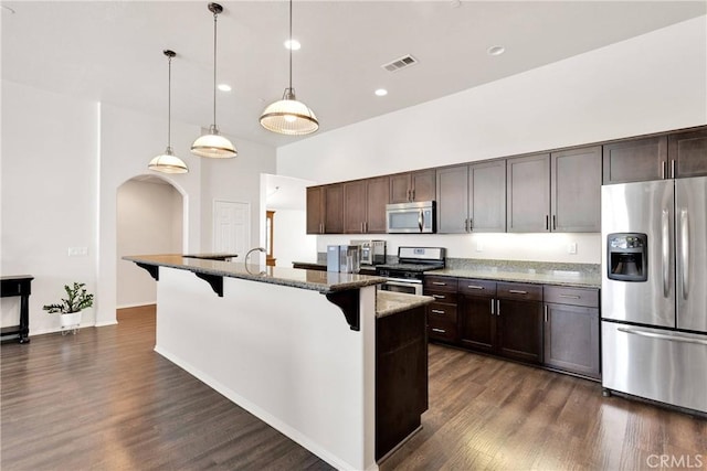 15558 Lookout Rd, Apple Valley, CA 92307 - kitchen with appliances with stainless steel finishes, dark wood finished floors, dark brown cabinetry, recessed lighting, and a high ceiling