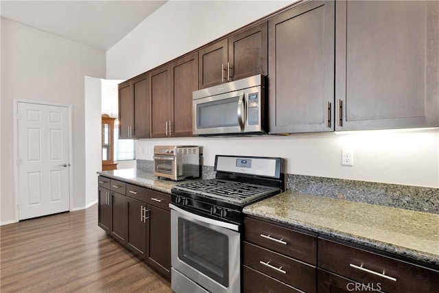 15558 Lookout Rd, Apple Valley, CA 92307 - kitchen with stainless steel appliances, dark brown cabinets, dark wood-style floors, and light stone countertops