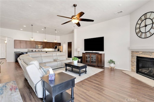 15558 Lookout Rd, Apple Valley, CA 92307 - living area featuring a ceiling fan, wood finished floors, recessed lighting, and a stone fireplace