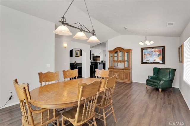 15558 Lookout Rd, Apple Valley, CA 92307 - dining room featuring lofted ceiling, wood finished floors, arched walkways, and a chandelier
