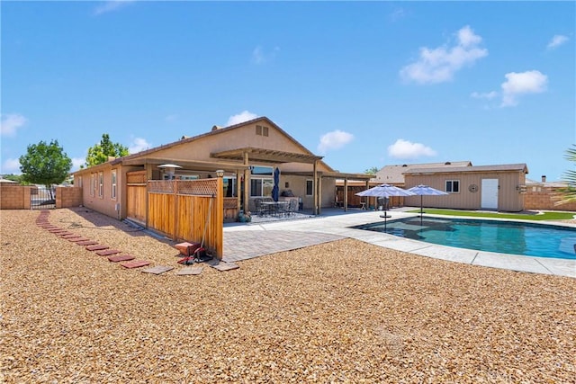 15558 Lookout Rd, Apple Valley, CA 92307 - view of swimming pool with a patio area, a gate, and an outbuilding