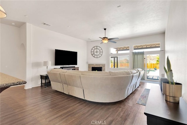 15558 Lookout Rd, Apple Valley, CA 92307 - living room with dark wood-type flooring, a fireplace, and ceiling fan