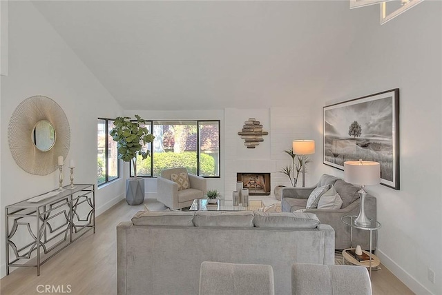 1207 Porto Grande Unit 1, Diamond Bar, CA 91765 - living area with light wood-style floors, vaulted ceiling, and a fireplace