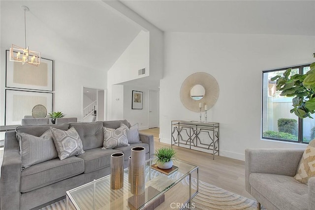 1207 Porto Grande Unit 1, Diamond Bar, CA 91765 - living room with light wood-style floors, a chandelier, high vaulted ceiling, stairs, and beam ceiling