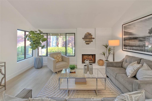 1207 Porto Grande Unit 1, Diamond Bar, CA 91765 - living area with lofted ceiling, wood finished floors, and a fireplace