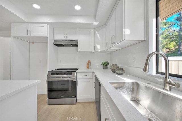 1207 Porto Grande Unit 1, Diamond Bar, CA 91765 - kitchen with stainless steel range with electric stovetop, range hood, a tray ceiling, white cabinets, and recessed lighting