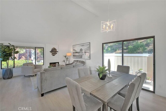 1207 Porto Grande Unit 1, Diamond Bar, CA 91765 - dining area with light wood finished floors, a chandelier, healthy amount of natural light, and high vaulted ceiling