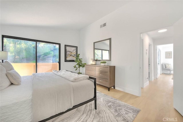 1207 Porto Grande Unit 1, Diamond Bar, CA 91765 - bedroom featuring vaulted ceiling, access to exterior, light wood finished floors, and multiple windows