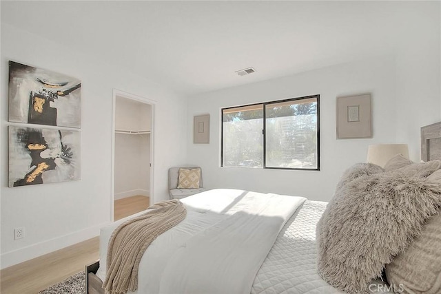 1207 Porto Grande Unit 1, Diamond Bar, CA 91765 - bedroom with light wood finished floors, a walk in closet, and a closet