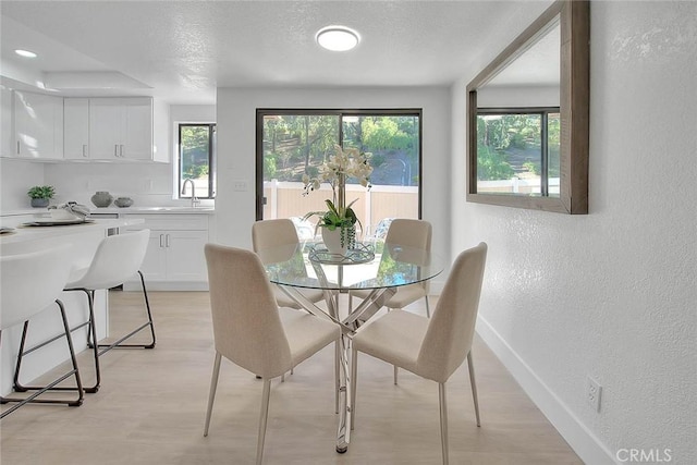 1207 Porto Grande Unit 1, Diamond Bar, CA 91765 - dining room with a textured wall, light wood-style flooring, and a textured ceiling