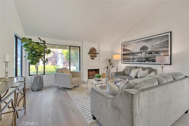 1207 Porto Grande Unit 1, Diamond Bar, CA 91765 - living room with lofted ceiling, wood finished floors, and a fireplace