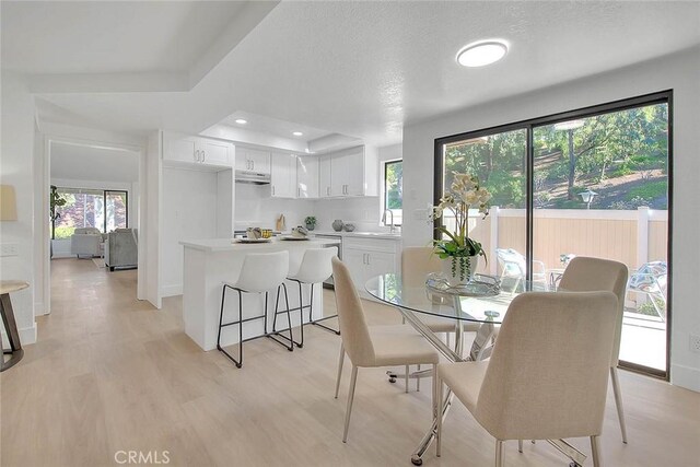 1207 Porto Grande Unit 1, Diamond Bar, CA 91765 - dining space with plenty of natural light, light wood-type flooring, a tray ceiling, and recessed lighting