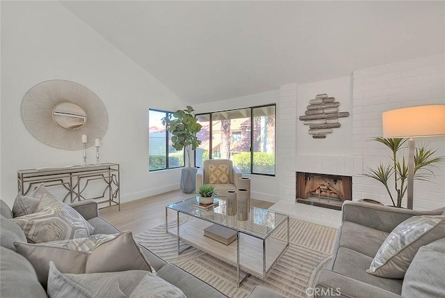1207 Porto Grande Unit 1, Diamond Bar, CA 91765 - living room featuring wood finished floors, a fireplace, and lofted ceiling