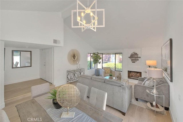 1207 Porto Grande Unit 1, Diamond Bar, CA 91765 - living area featuring high vaulted ceiling, a chandelier, light wood-type flooring, plenty of natural light, and a fireplace