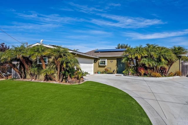 2722 Penkea Dr, Oceanside, CA 92054 - view of front of home featuring concrete driveway, solar panels, a front yard, a garage, and stucco siding