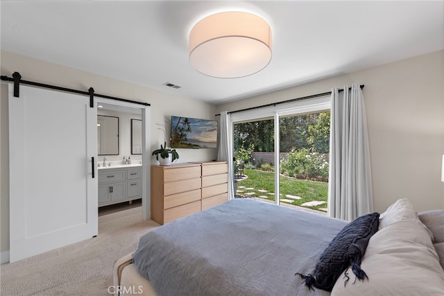30361 Via Alcazar Ave, Laguna Niguel, CA 92677 - bedroom featuring a barn door, light colored carpet, and ensuite bath